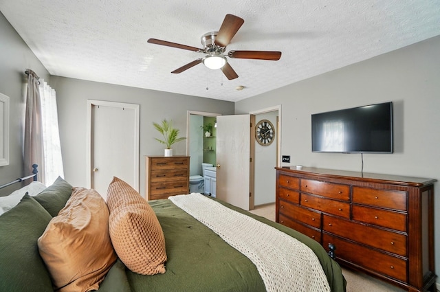 5694 Danmar Dr, Canal Winchester, OH 43110 - bedroom with a textured ceiling, carpet flooring, connected bathroom, and a ceiling fan