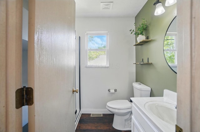 5694 Danmar Dr, Canal Winchester, OH 43110 - bathroom featuring vanity, wood finished floors, toilet, baseboards, and a shower