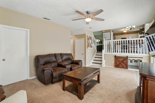 5694 Danmar Dr, Canal Winchester, OH 43110 - living area featuring light carpet, ceiling fan, a textured ceiling, stairs, and baseboards