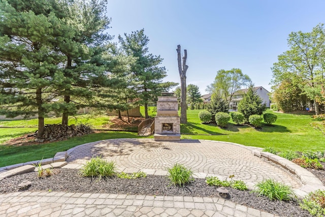 view of community with a patio and a lawn