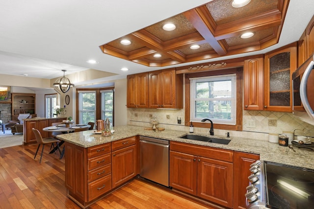 kitchen featuring stainless steel dishwasher, coffered ceiling, light wood-style flooring, range with electric stovetop, and a sink