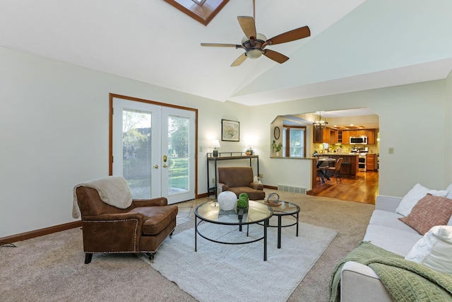 carpeted living room featuring visible vents, french doors, high vaulted ceiling, and baseboards