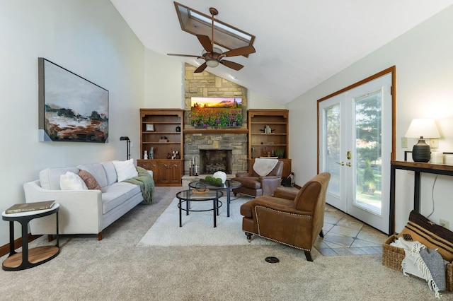 carpeted living room with a ceiling fan, a fireplace, and lofted ceiling