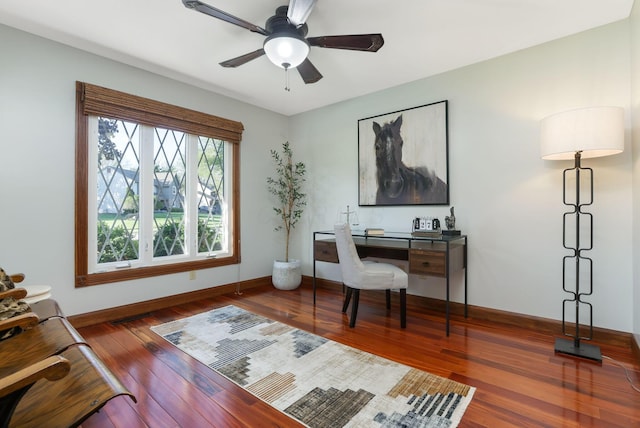 office space with a ceiling fan, wood finished floors, and baseboards
