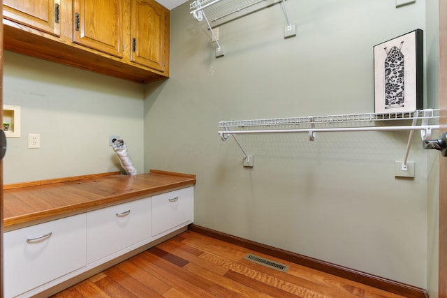spacious closet with visible vents and light wood-style flooring