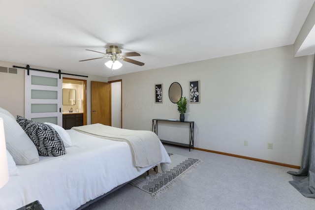 bedroom featuring connected bathroom, light carpet, baseboards, visible vents, and a ceiling fan