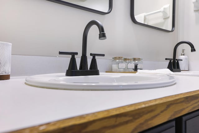 room details featuring double vanity and a sink
