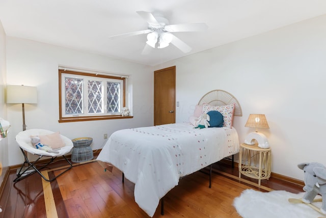 bedroom featuring a ceiling fan, wood finished floors, and baseboards