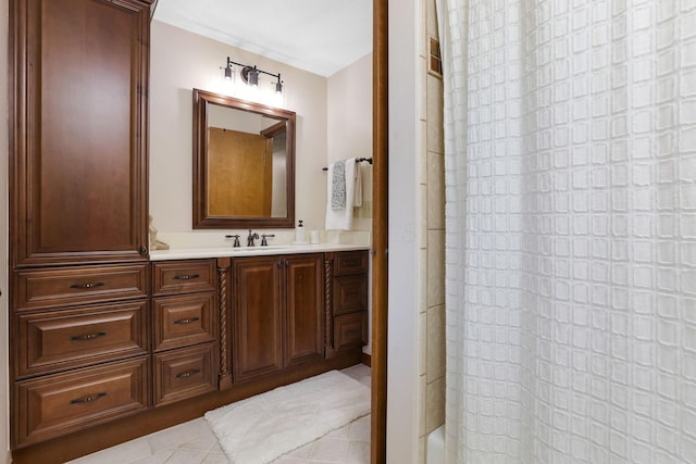 full bath featuring curtained shower, tile patterned flooring, and vanity