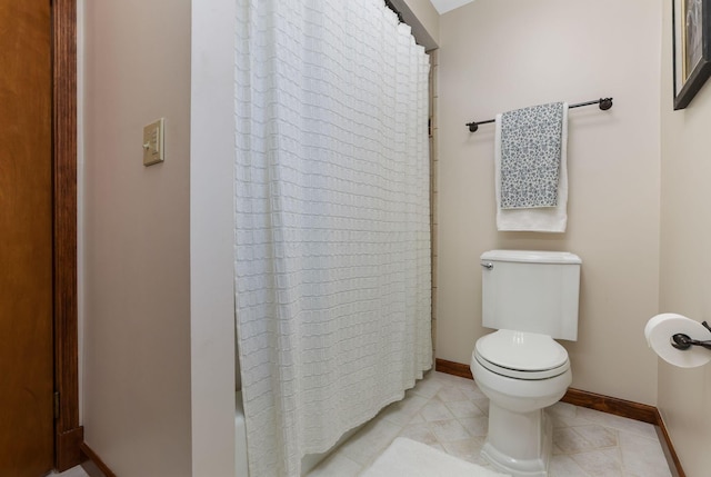 full bath with baseboards, tile patterned floors, and toilet