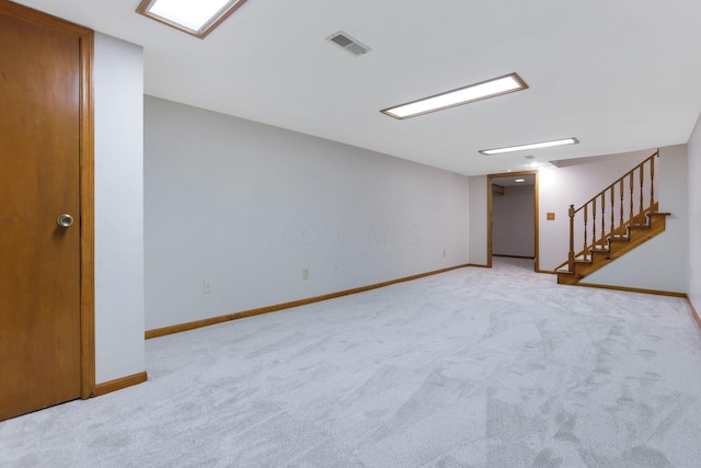 unfurnished room with visible vents, baseboards, stairs, and carpet floors