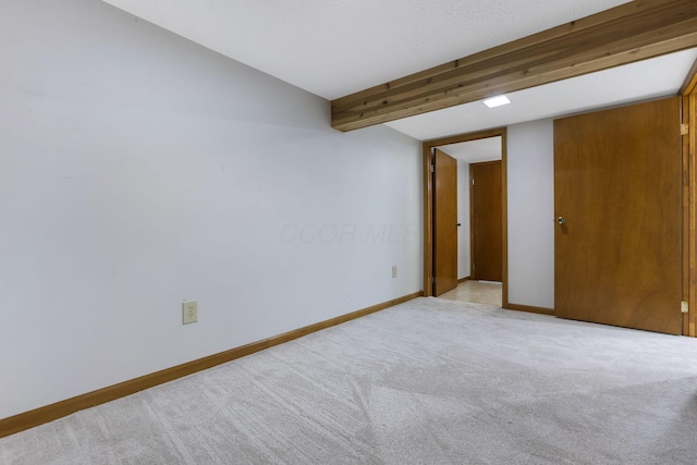 unfurnished room featuring carpet floors and baseboards