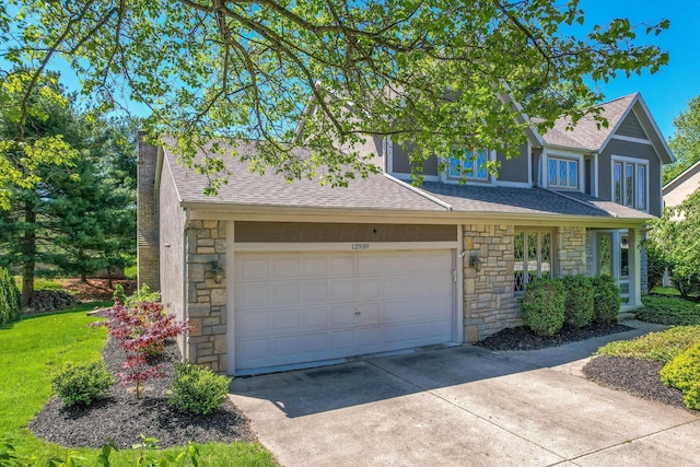 view of front of home featuring a shingled roof, driveway, and stone siding