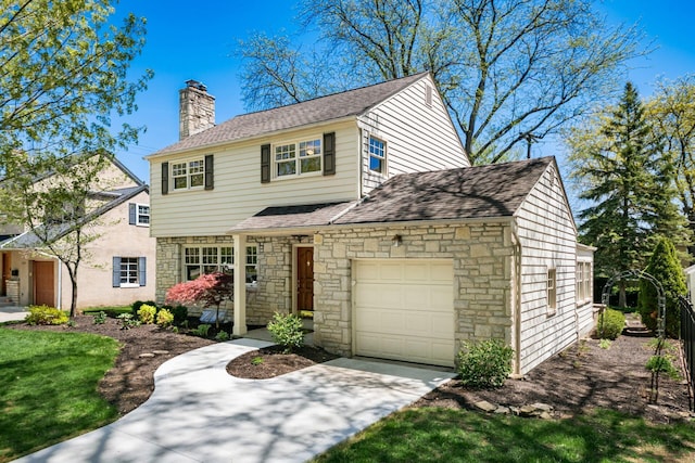 traditional-style home featuring an attached garage, driveway, a chimney, and stone siding