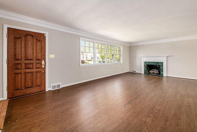 unfurnished living room featuring crown molding, baseboards, visible vents, and dark wood finished floors