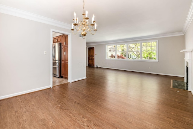 unfurnished living room with a fireplace with flush hearth, wood finished floors, baseboards, a chandelier, and ornamental molding