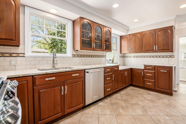 kitchen featuring stainless steel dishwasher, crown molding, tasteful backsplash, a sink, and range