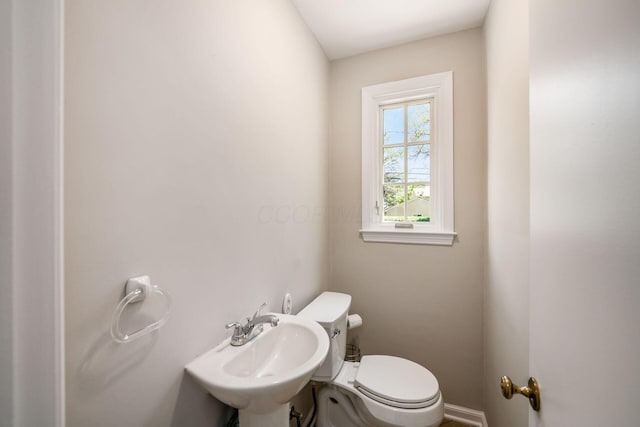 half bath with a sink and toilet