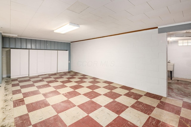 basement with light floors and concrete block wall