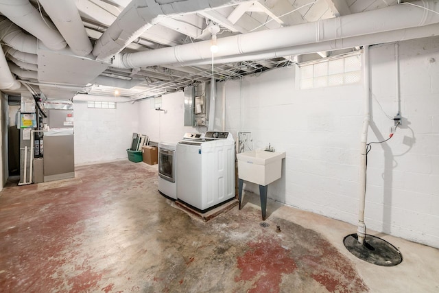 basement with heating unit and washer and dryer