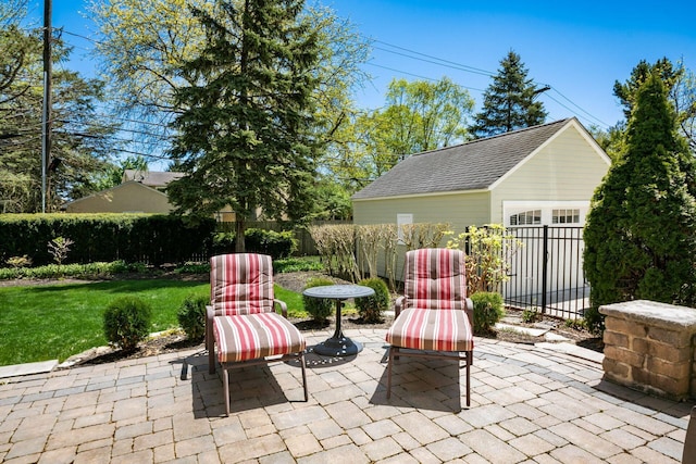 view of patio featuring fence and an outbuilding