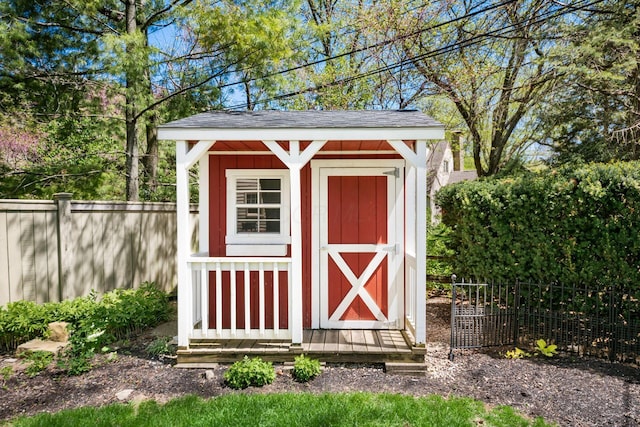 view of shed featuring fence
