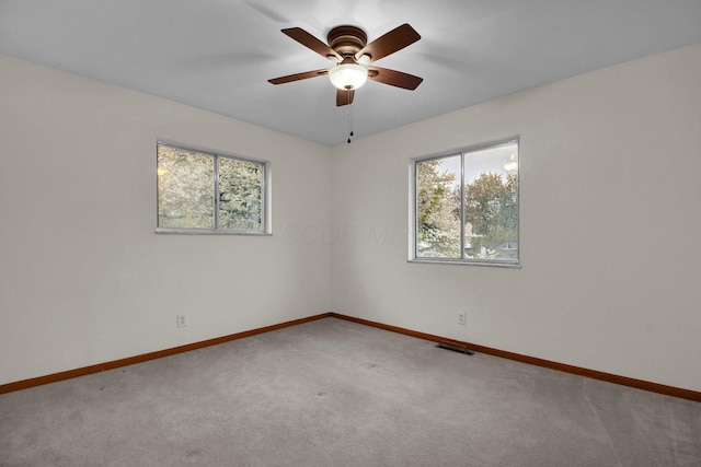 empty room with visible vents, baseboards, and a wealth of natural light