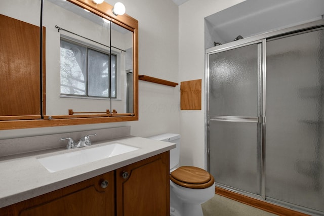 full bathroom with vanity, a stall shower, and toilet