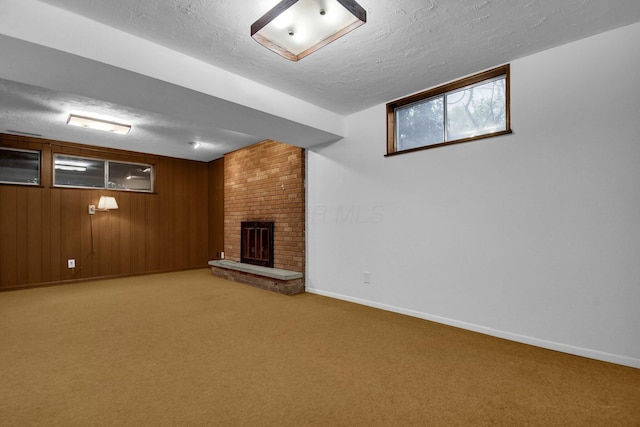 below grade area with baseboards and a textured ceiling