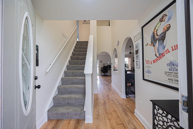 380 Oak Village Dr, Columbus, OH 43207 - entryway with arched walkways, light wood finished floors, stairway, and baseboards