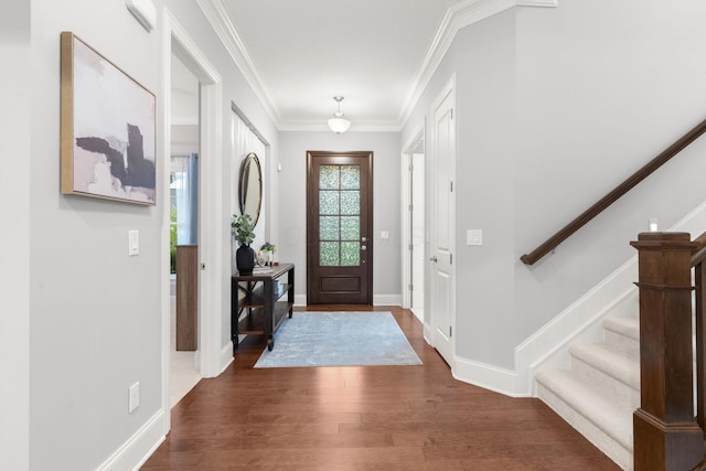 foyer with crown molding, baseboards, stairs, and wood finished floors