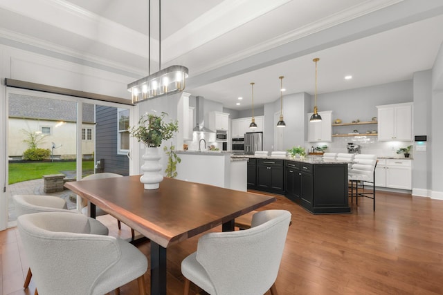 dining room with recessed lighting, ornamental molding, and dark wood-style flooring