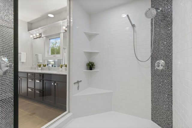 full bathroom featuring vanity and tiled shower
