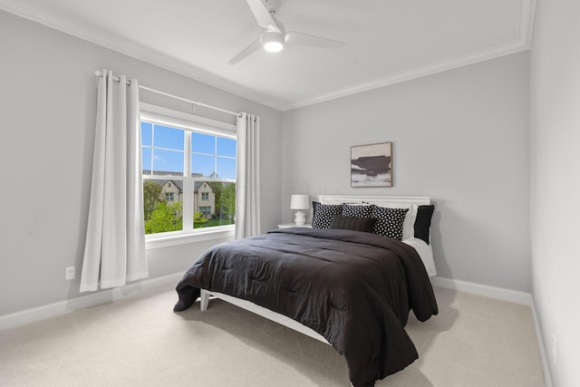 bedroom with crown molding, baseboards, and light carpet