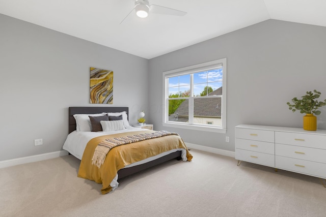 bedroom featuring baseboards, ceiling fan, vaulted ceiling, and light colored carpet