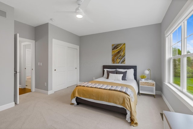 bedroom featuring carpet floors, baseboards, and multiple windows
