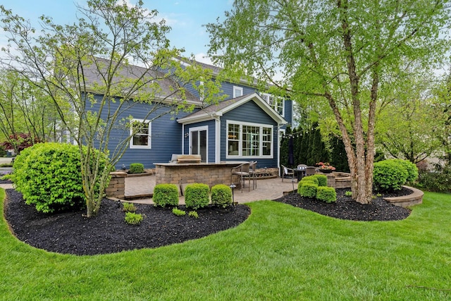 back of house featuring a patio and a yard