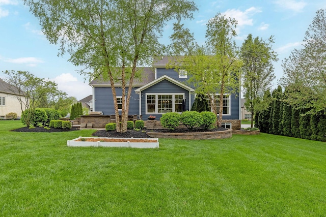 back of property with a lawn