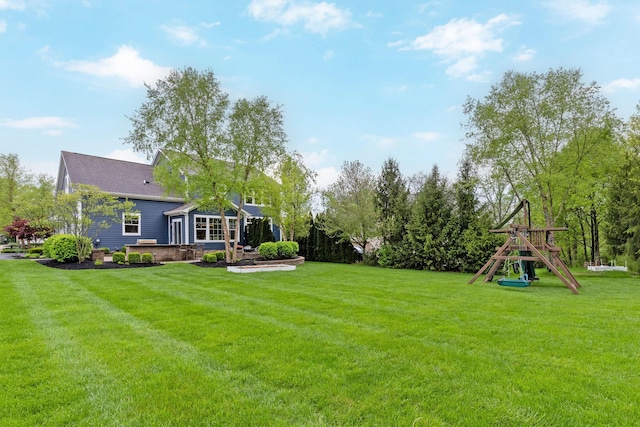 view of yard featuring a playground and a patio area