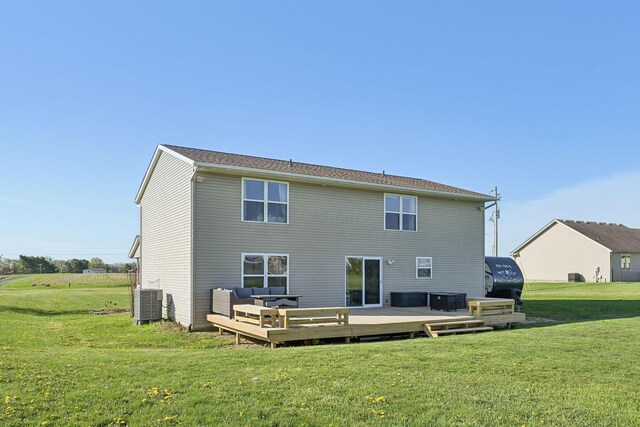 rear view of house featuring an outdoor living space, a lawn, a deck, and central AC