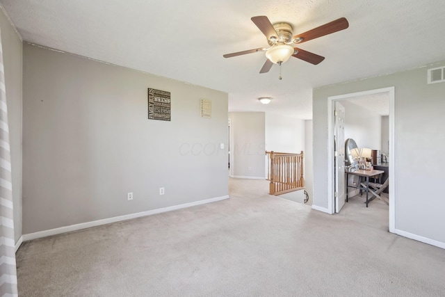 empty room featuring baseboards, ceiling fan, and carpet flooring