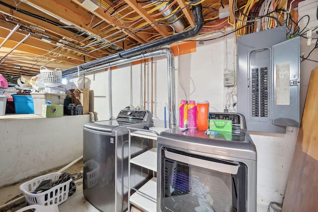 clothes washing area with independent washer and dryer, electric panel, and laundry area