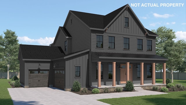 view of front of property featuring a front lawn, board and batten siding, fence, and covered porch