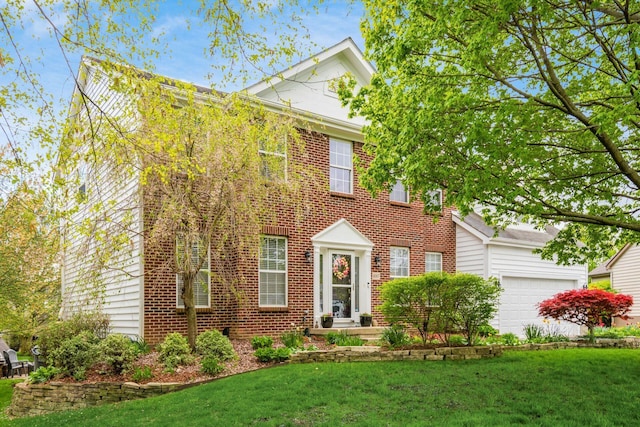 colonial inspired home with brick siding and a front yard