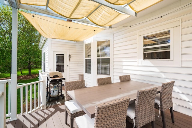deck featuring outdoor dining space and area for grilling