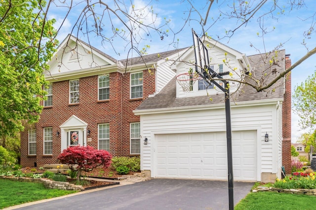 view of front of property with aphalt driveway, a shingled roof, brick siding, and a garage