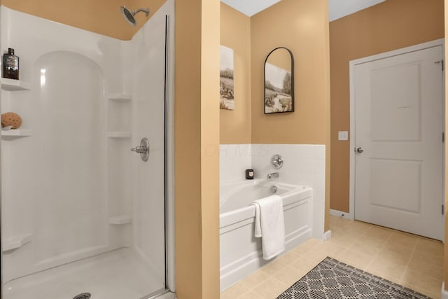 full bath featuring baseboards, a shower stall, and a bath