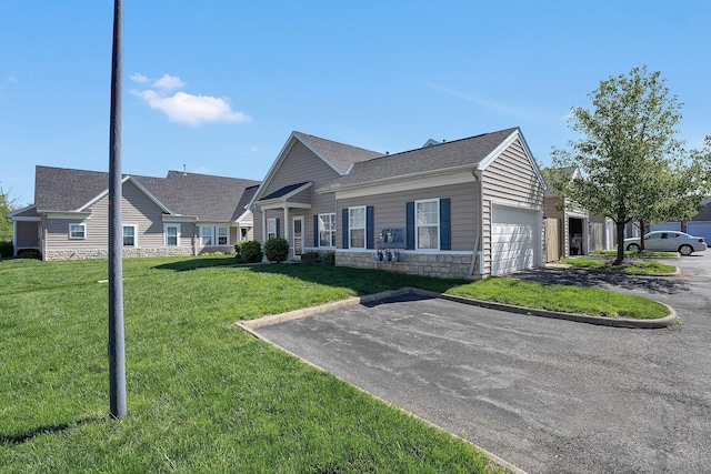 ranch-style home with an attached garage, driveway, stone siding, and a front lawn