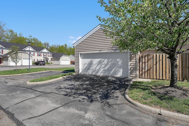 garage featuring a residential view and driveway