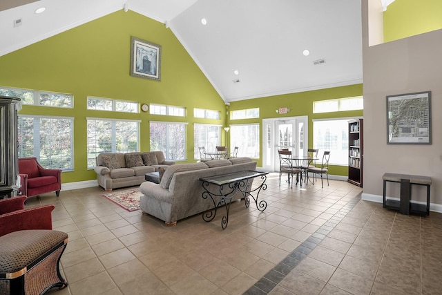 living area with plenty of natural light, tile patterned floors, and high vaulted ceiling